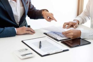 Family reviews health insurance documents and compares plan costs at a kitchen table.